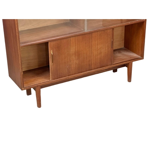 126 - A Mid Century Tola Wood bookcase by Beaver & Tapley. 107x27x102cm