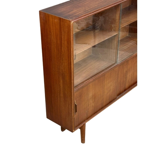 126 - A Mid Century Tola Wood bookcase by Beaver & Tapley. 107x27x102cm