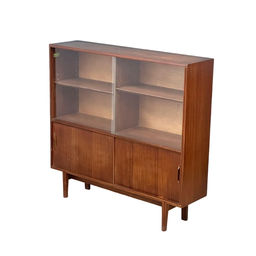 126 - A Mid Century Tola Wood bookcase by Beaver & Tapley. 107x27x102cm