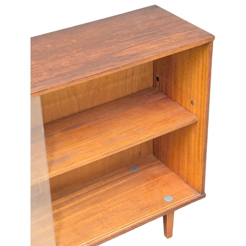 143 - A Mid Century teak bookcase by Avalon. 114x31x74.5cm