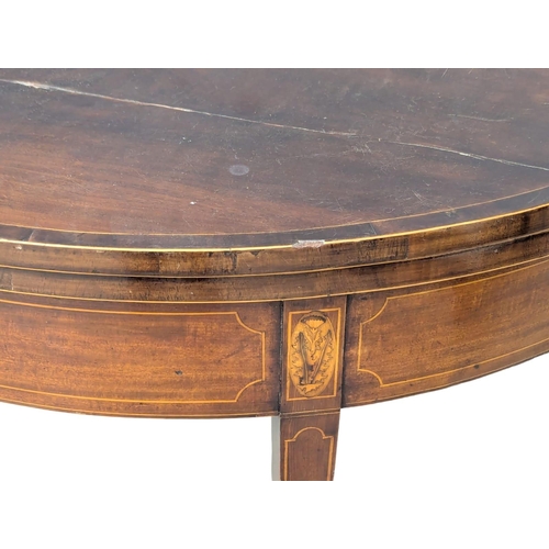 165 - A George III Sheraton style inlaid mahogany turnover games table. Circa 1800s. 96x46x75cm