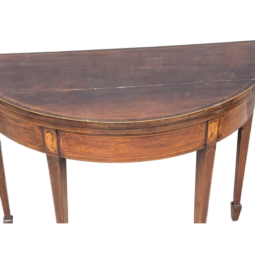 165 - A George III Sheraton style inlaid mahogany turnover games table. Circa 1800s. 96x46x75cm