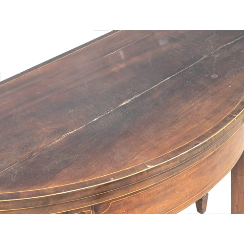 165 - A George III Sheraton style inlaid mahogany turnover games table. Circa 1800s. 96x46x75cm