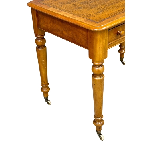 191 - A 19th Century Victorian 2 drawer writing table, with original leather top, turned legs on brass cup... 