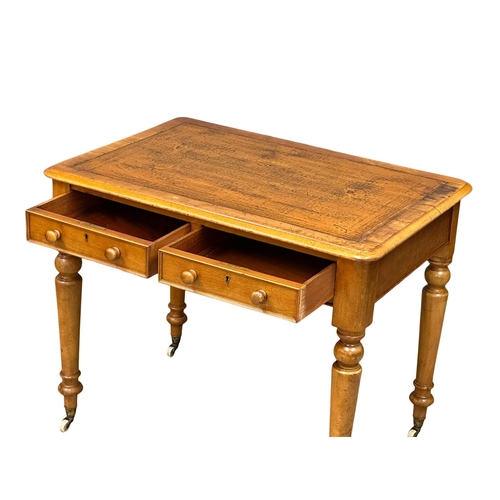 191 - A 19th Century Victorian 2 drawer writing table, with original leather top, turned legs on brass cup... 