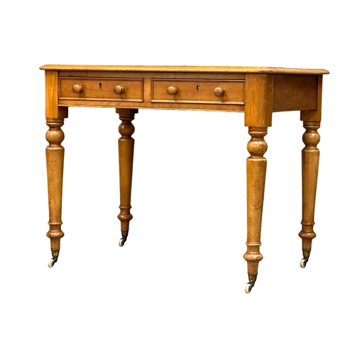 191 - A 19th Century Victorian 2 drawer writing table, with original leather top, turned legs on brass cup... 