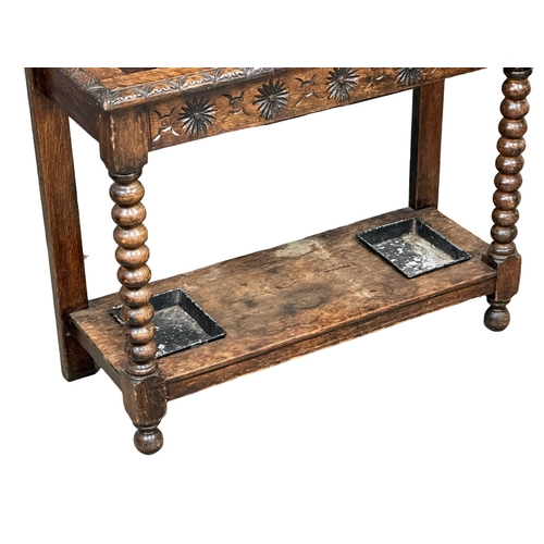 218 - A large Late 19th Century Victorian carved oak hallstand. With bobbin turn supports, front rail and ... 