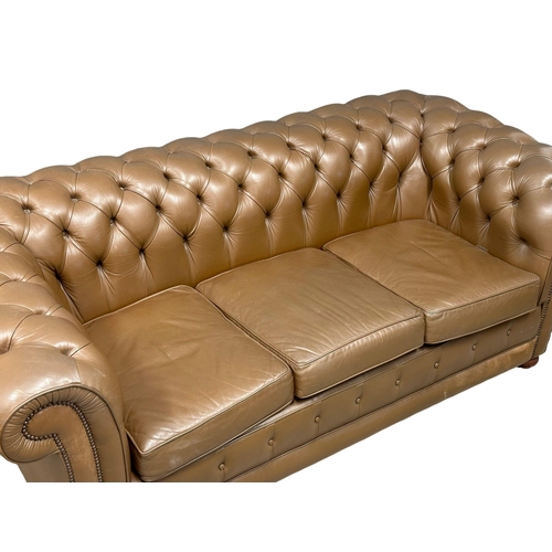 238 - A leather deep button back 3 seater sofa. 202cm