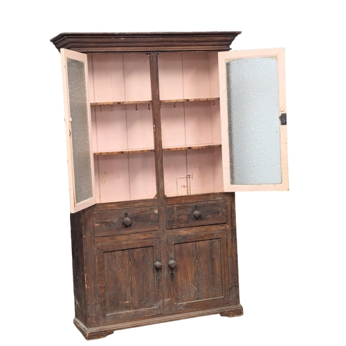 25 - A Mid 19th Century Irish pine kitchen cabinet in original scumble finish with fitted shaped shelves.... 