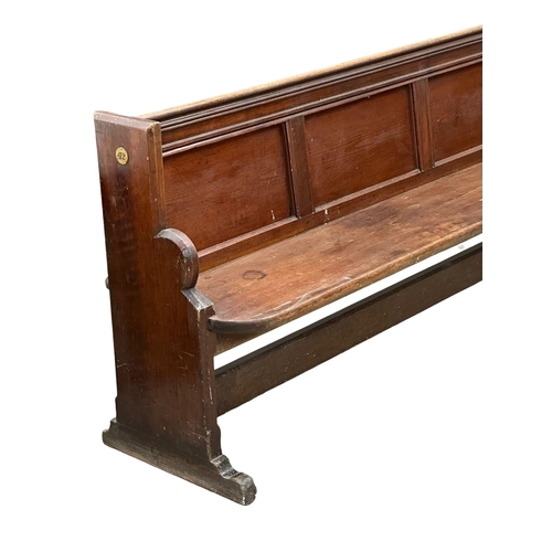 266 - A very large Late Victorian pitch pine church pew/bench. 356cm