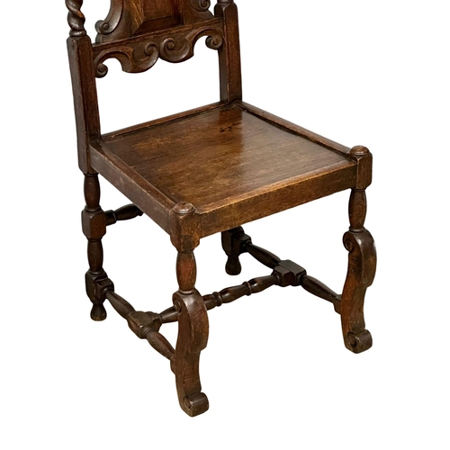 350 - A pair of large Late 19th Century oak hall chairs in the Charles II Carolean style.