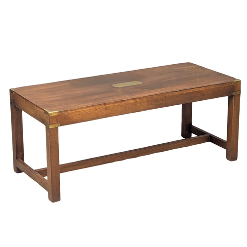 515 - A vintage mahogany campaign style coffee table with brass mounts. 107x46x44cm