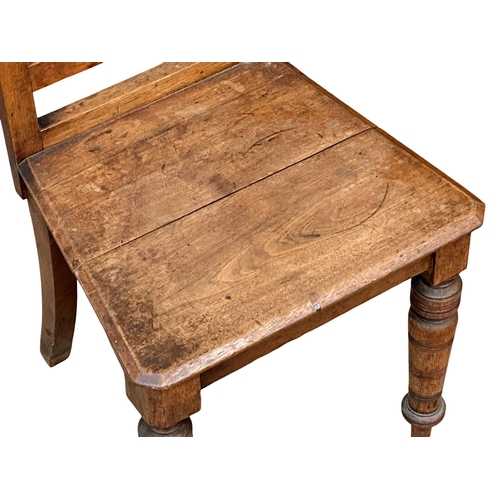 524 - A Late 19th Century Victorian oak hall chair with tiled back. Circa 1880.