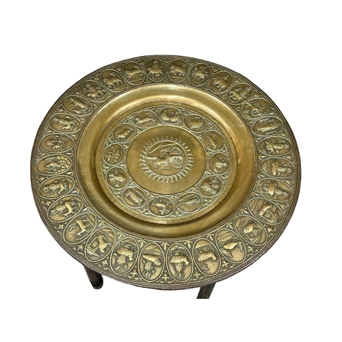 55 - A large Late 19th Century Indian brass top folding table. 76.5x51.5cm