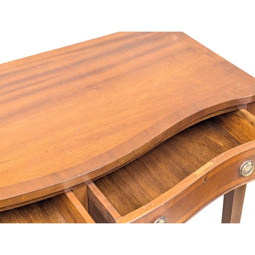 555 - A Hepplewhite style mahogany hall table with serpentine front on square tapering legs. 99x47x86cm