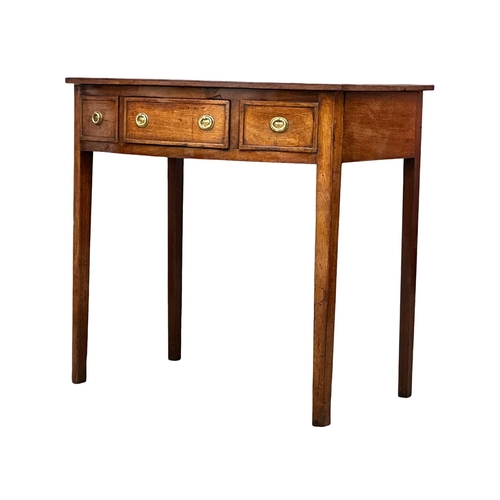 57 - A Late 18th Century George III mahogany bow front writing table with leather top on square tapering ... 