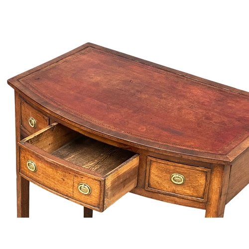 57 - A Late 18th Century George III mahogany bow front writing table with leather top on square tapering ... 