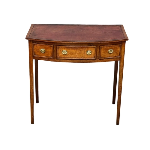 57 - A Late 18th Century George III mahogany bow front writing table with leather top on square tapering ... 