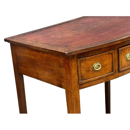 57 - A Late 18th Century George III mahogany bow front writing table with leather top on square tapering ... 