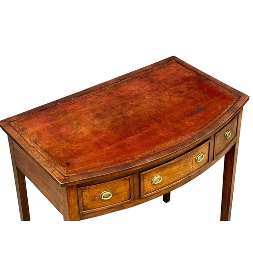 57 - A Late 18th Century George III mahogany bow front writing table with leather top on square tapering ... 