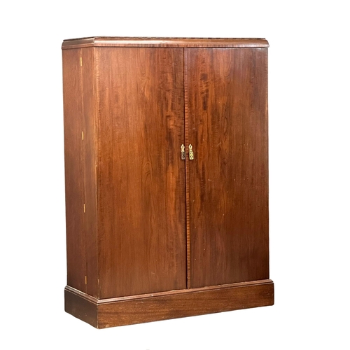 830 - A large vintage mahogany fitted gents wardrobe. 124x53x175cm