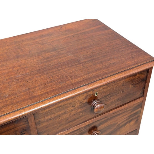 97 - A 19th Century Victorian mahogany chest of drawers with bun handles on splayed feet. 110x51x113cm