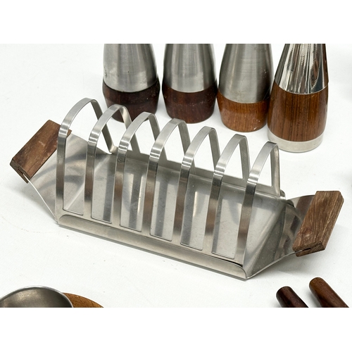 147A - A quantity of Danish Mid Century tableware. Danish egg holders, salt and pepper shakers, toast rack,... 