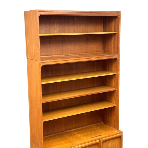 263 - A large Mid Century teak Chiswell open bookcase, with lower cupboard and maple interior. 118x45x222c... 