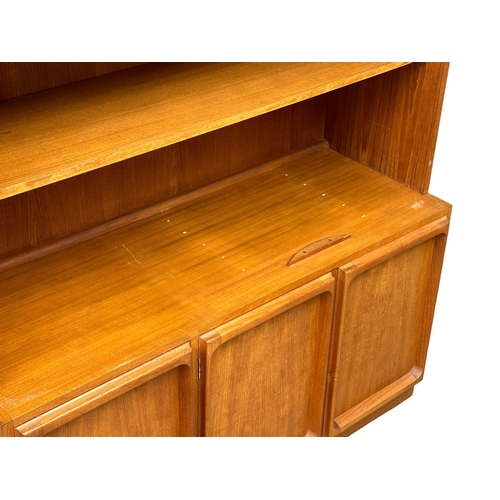 263 - A large Mid Century teak Chiswell open bookcase, with lower cupboard and maple interior. 118x45x222c... 