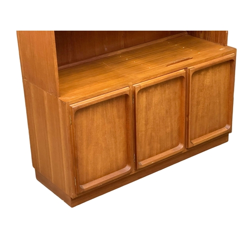 263 - A large Mid Century teak Chiswell open bookcase, with lower cupboard and maple interior. 118x45x222c... 