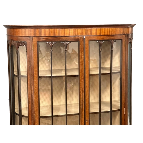 323 - A large Edwardian mahogany bow front display cabinet, with astragal glazed doors and ball on claw fe... 