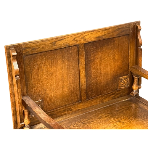 395 - A 17th Century style oak combination hall bench/hall table. Closed 107x57x74cm. Closed 96x48x104cm