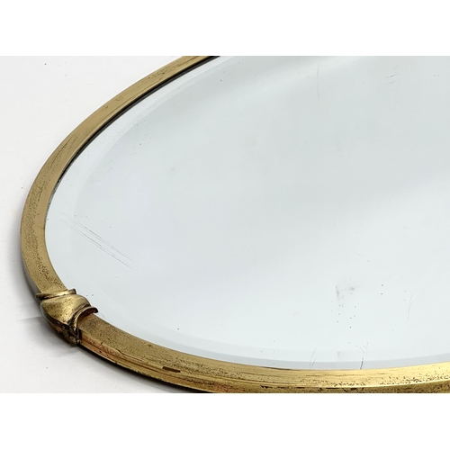 477 - An Early 20th Century Art & Crafts brass framed mirror. Circa 1900. 78x51cm