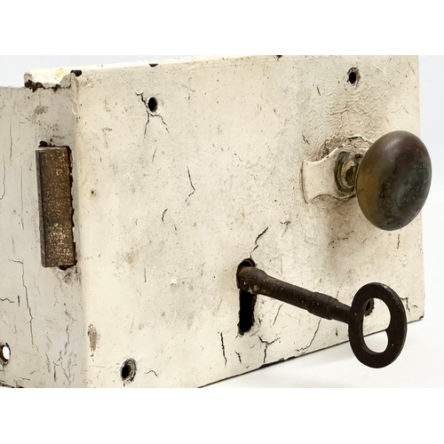 497 - A large Victorian rim lock/door lock. With original key. 26x15cm.