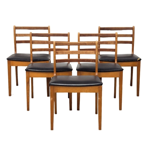 494 - A Mid Century teak and beech extending dining table and 5 dining chairs.(3)