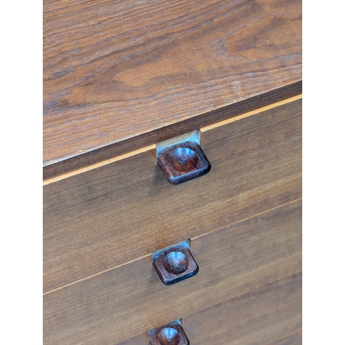 12 - A pair of Danish Mid Century teak chests of drawers with rosewood handles. 61x56x59cm