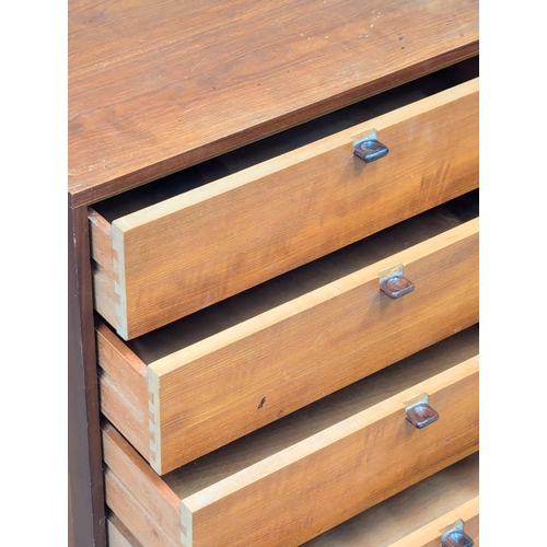 12 - A pair of Danish Mid Century teak chests of drawers with rosewood handles. 61x56x59cm