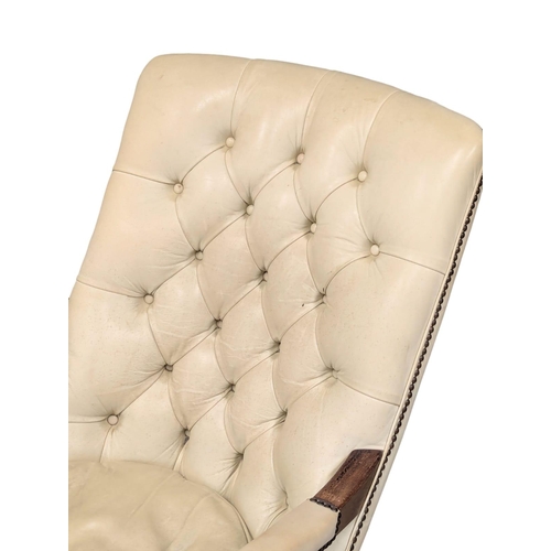 475 - A William IV style deep button back leather armchair.