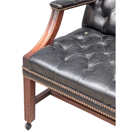 52 - A Gainsborough style deep button back leather armchair