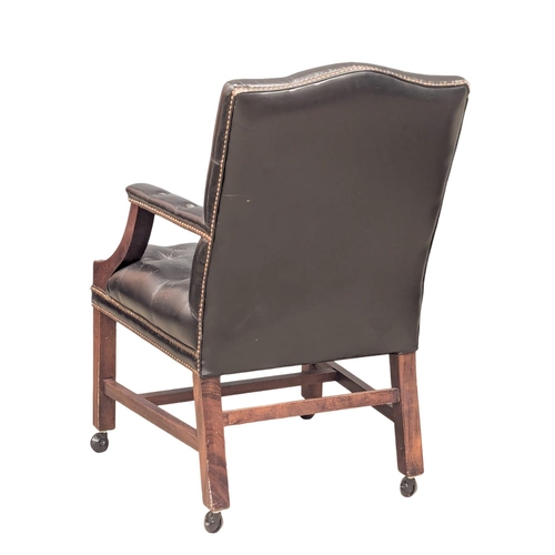 52 - A Gainsborough style deep button back leather armchair