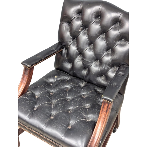 52 - A Gainsborough style deep button back leather armchair