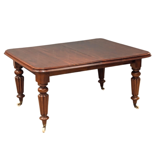 508A - A large Early Victorian mahogany telescopic dining table on turned reeded legs. Circa 1840s. 2 leave... 