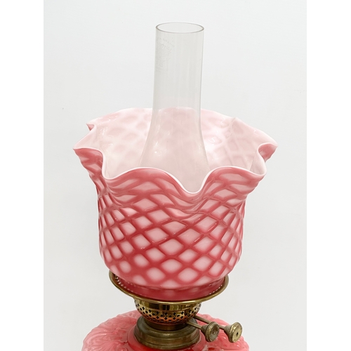 119 - A large Late 19th Century Victorian double burner, opaline glass oil lamp. With diamond shade, embos... 