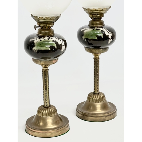 120 - A pair of Late 19th Century Victorian piano oil lamps. With ceramic bowls on brass columns. 49cm