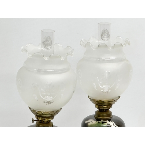 120 - A pair of Late 19th Century Victorian piano oil lamps. With ceramic bowls on brass columns. 49cm