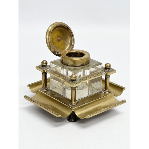 181 - A Late 19th Century Victorian brass inkstand with cut glass inkwell. 12x12x10cm.