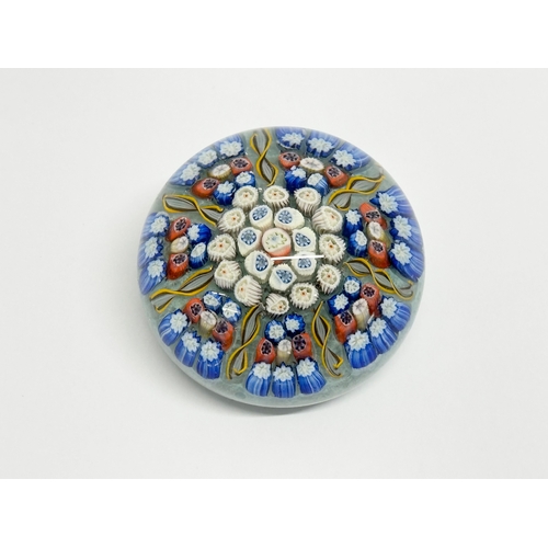 104 - John Deacons. A millefiori glass paperweight. 6x5cm