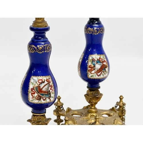 86 - A pair of Late 19th Century French gilt brass candlesticks with covers and hand painted cobalt blue ... 