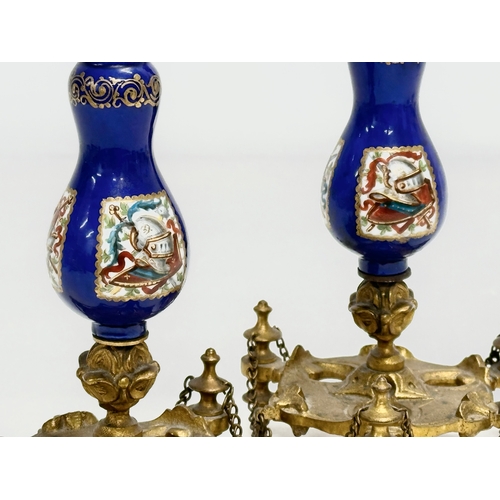 86 - A pair of Late 19th Century French gilt brass candlesticks with covers and hand painted cobalt blue ... 