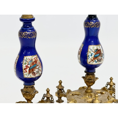 86 - A pair of Late 19th Century French gilt brass candlesticks with covers and hand painted cobalt blue ... 